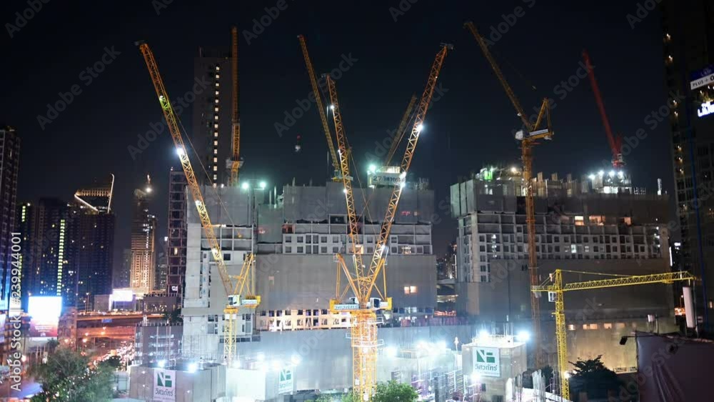 4K Night time lapse of working tower cranes at construction site 4K Night time lapse of working tower cranes at construction site