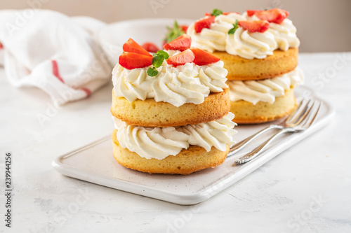 Strawberry cake with vanilla cream on white background. Copy space.