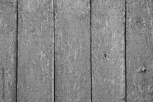 Black and white wooden background of vertical wooden boards with peeling paint. Organic texture. Black and white