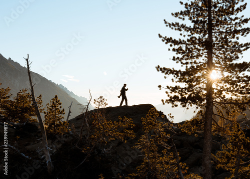 hiker silhouette during sunrise in the mountains