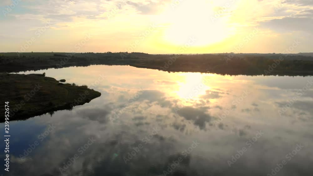 fisherman in a boat catches fish at sunset. The fairy tale of the sun is reflected in the water. Sonets shines in the camera. Aerial view. fisherman in a boat catches fish at sunset. The fairy tale of the sun is reflected in the water. Sonets shines in the camera. Aerial view.