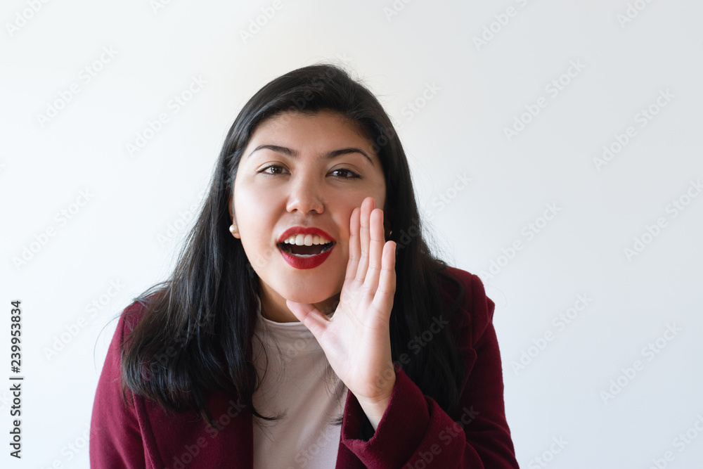 Excited girl shouting loud with hand at mouth. Young Asian woman sharing important news. Announcing or advertising concept Excited girl shouting loud with hand at mouth. Young Asian woman sharing important news. Announcing or advertising concept