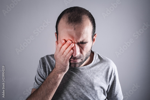 Caucasian man with eye pain. Eye disease