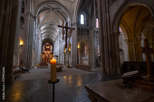 Interior of catholic cathedral  candle at foreground
