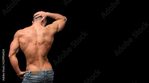 Man's strong fitness back isolated on dark background
