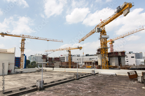 Construction Cranes Against Blue Sky