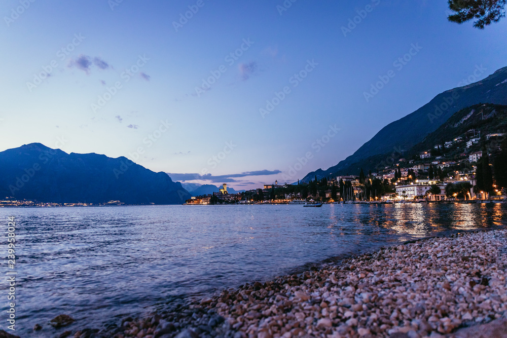 Evening scene at lago di garda: Beach, lake and village