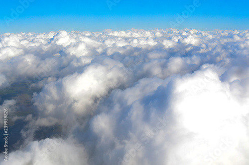 sky with fluffy clouds, the view from the plane, flying on an airplane