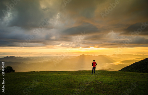 successful man hiker on top mountain - man standing on hill with sun rise / landscape mountain