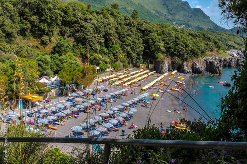 Fototapeta Naklejka Na Ścianę i Meble -  Maratea, Italy - A beautiful rocky beach (Lido Macarro Spiaggia Marateaer) at. Maratea on the coast at the Tyrrhenian Sea (Mar Tirreno) in the south of Italy on a sunny day in June.