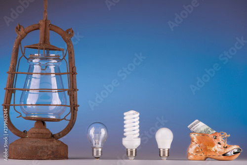 Old and modern light led bulbs on blue background