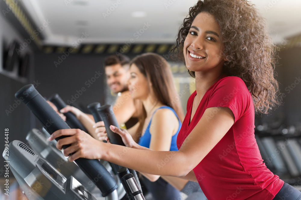 African american fitness exercising on cross trainer in gym Stock