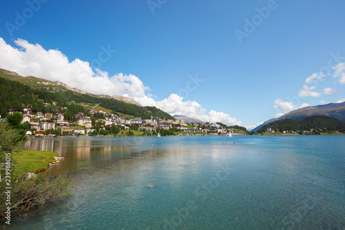 Sankt Moritz town and lake with transparent water in a sunny summer day in Switzerland
