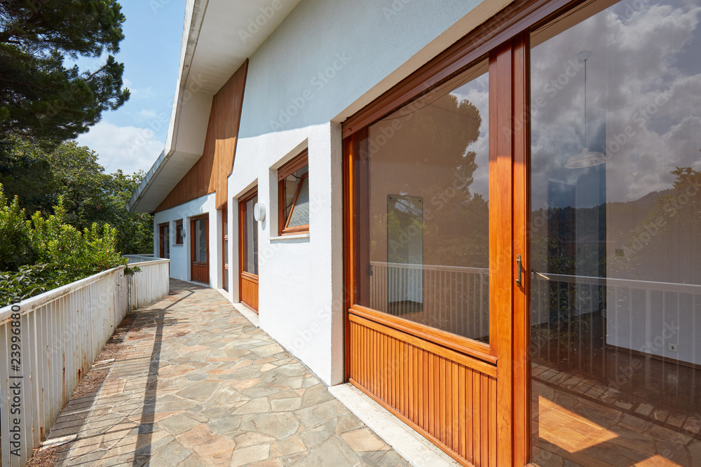 Large terrace and room interior in sunny country house