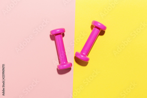 Dumbbells flat lay on pink and yellow © nerudol