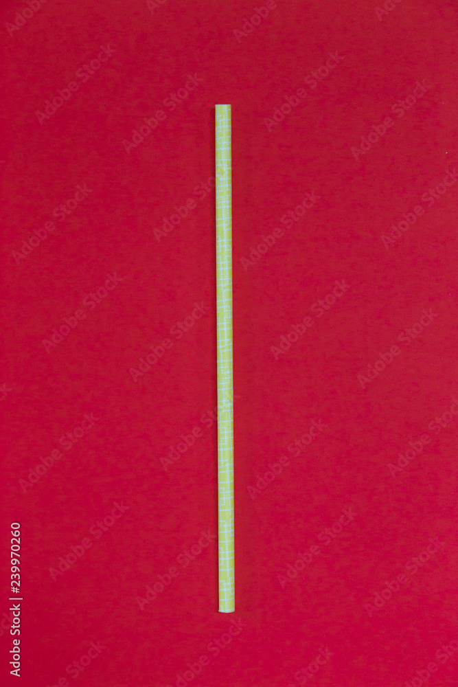 Yellow paper straw on red background. Yellow paper straw on red background.