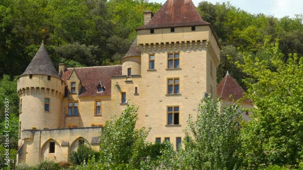 Chateau de la Malartrie seen from a river cruise in Dordogne river, France Chateau de la Malartrie seen from a river cruise in Dordogne river, France