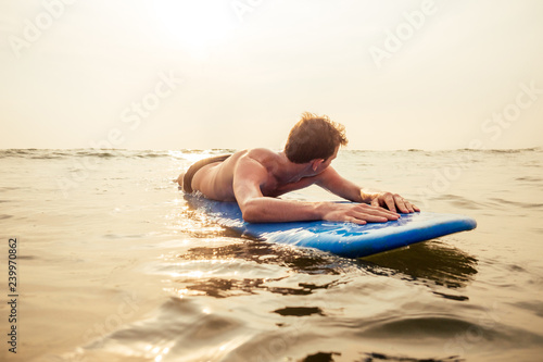 Canvas Print handsome young man enjoying a surf in water