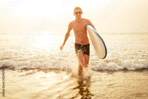 Photography handsome young man enjoying a surf in water