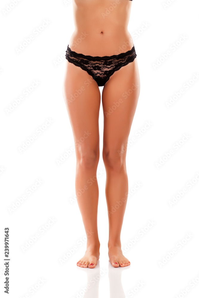 Beautiful woman legs and black lace panties on white background Beautiful woman legs and black lace panties on white background