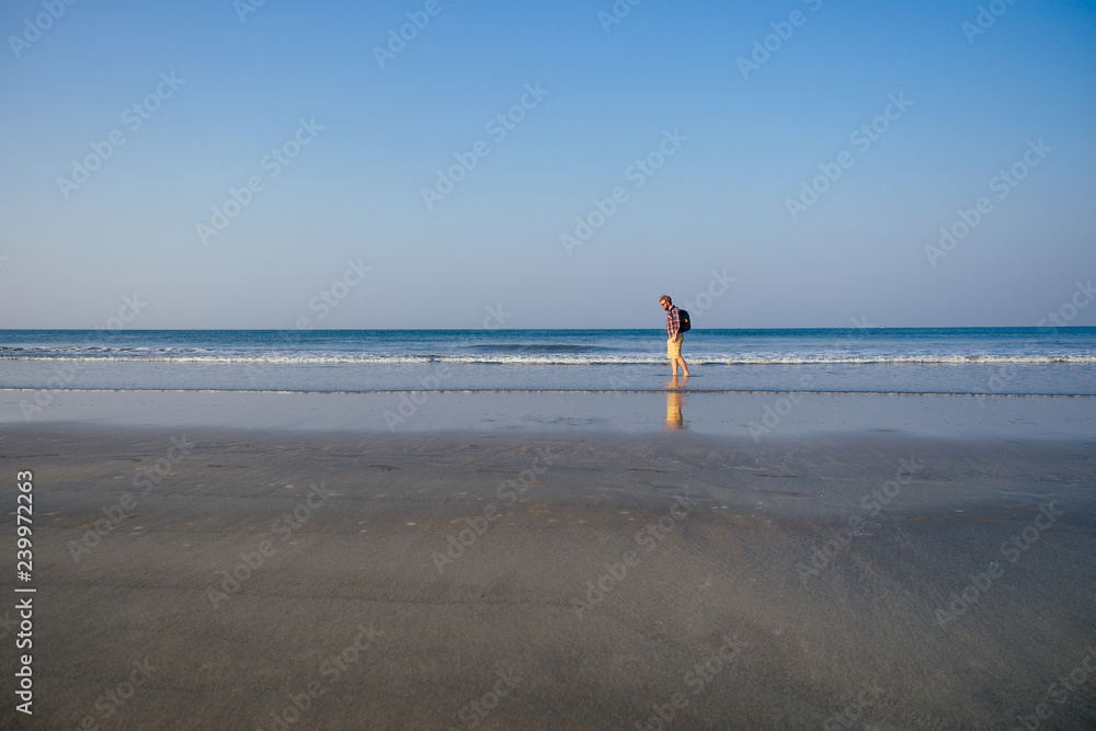 Obraz premium copy space caucasian man training on the beach in morning. Young fitness male on morning run outdoors copyspace sky, sea landscape.healthy way,cardio and detox