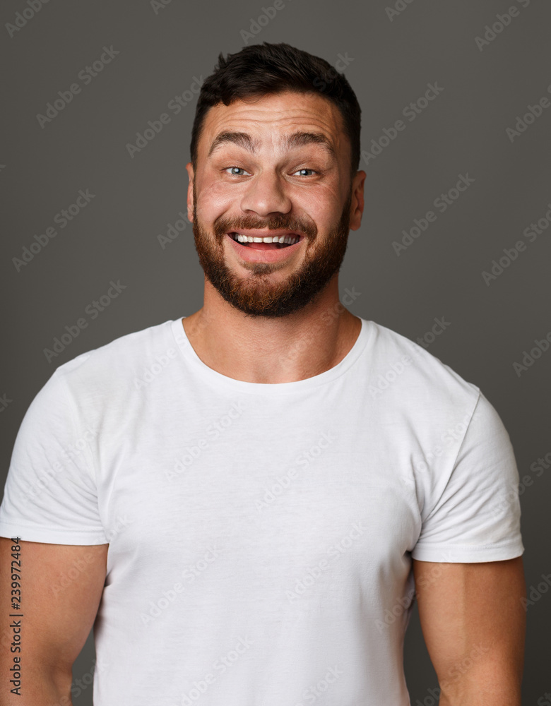 Smiley guy in white t-shirt studio portrait Smiley guy in white t-shirt studio portrait
