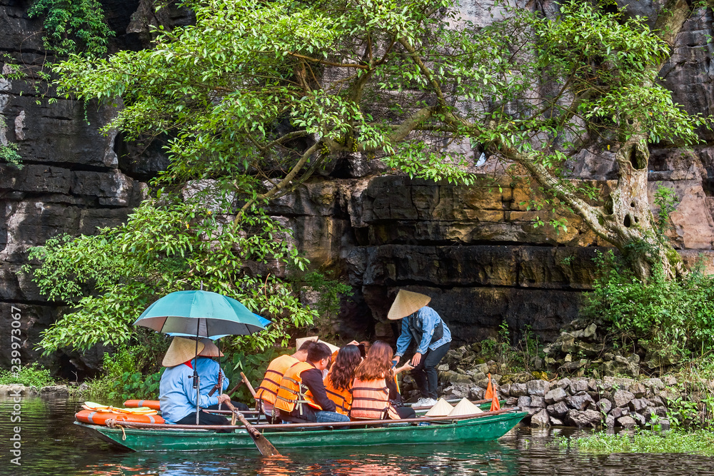 Rowboat with tourists view in Trang An, Ninh Binh, Vietnam