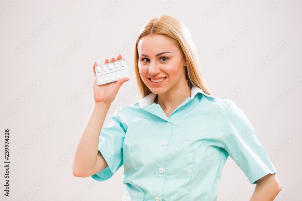 Portrait of young nurse who is holding pills. Portrait of young nurse who is holding pills.