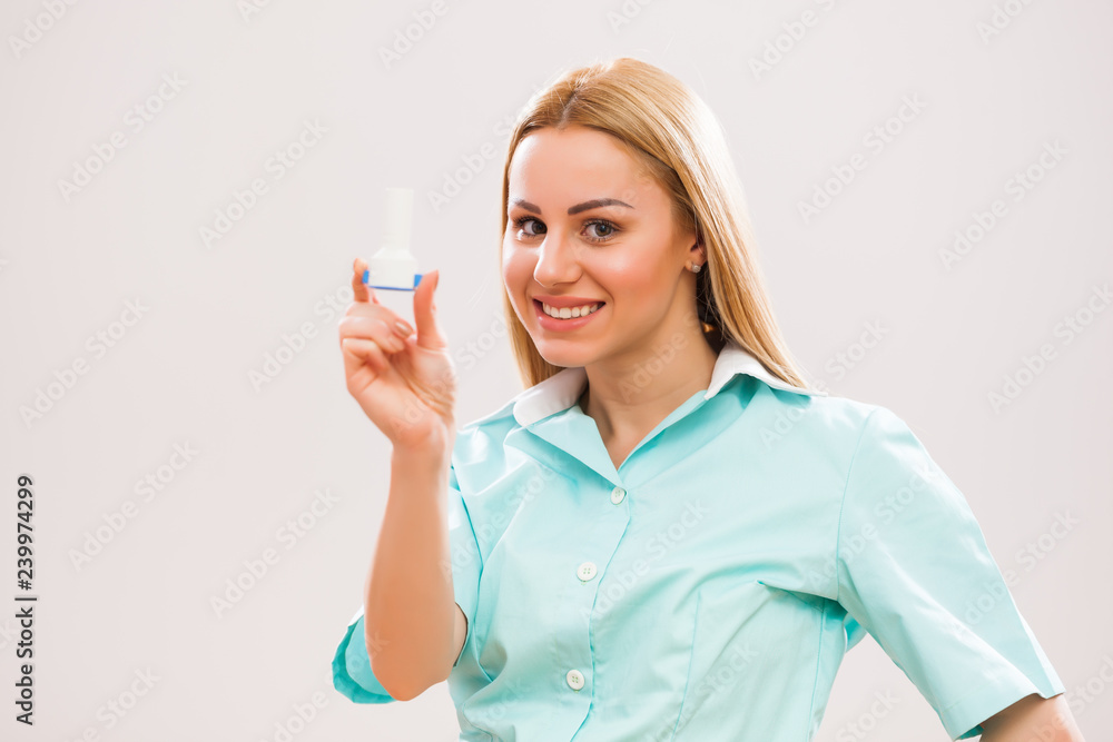 Portrait of young doctor who is holding inhaler. Portrait of young doctor who is holding inhaler.