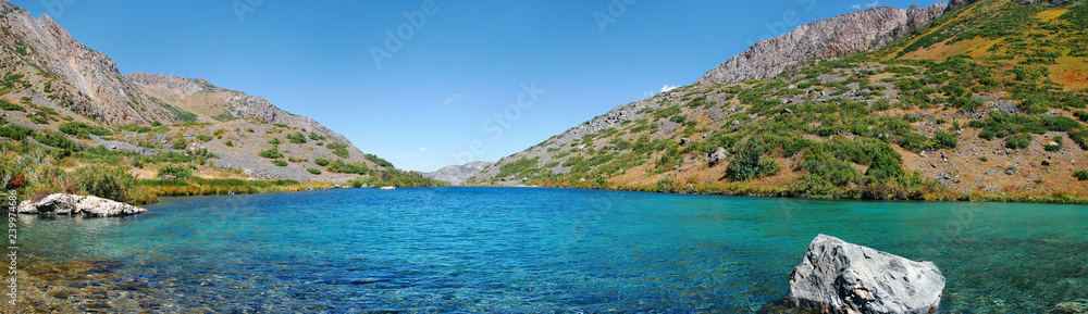 Alpine turquoise lake in autumn on a sunny day