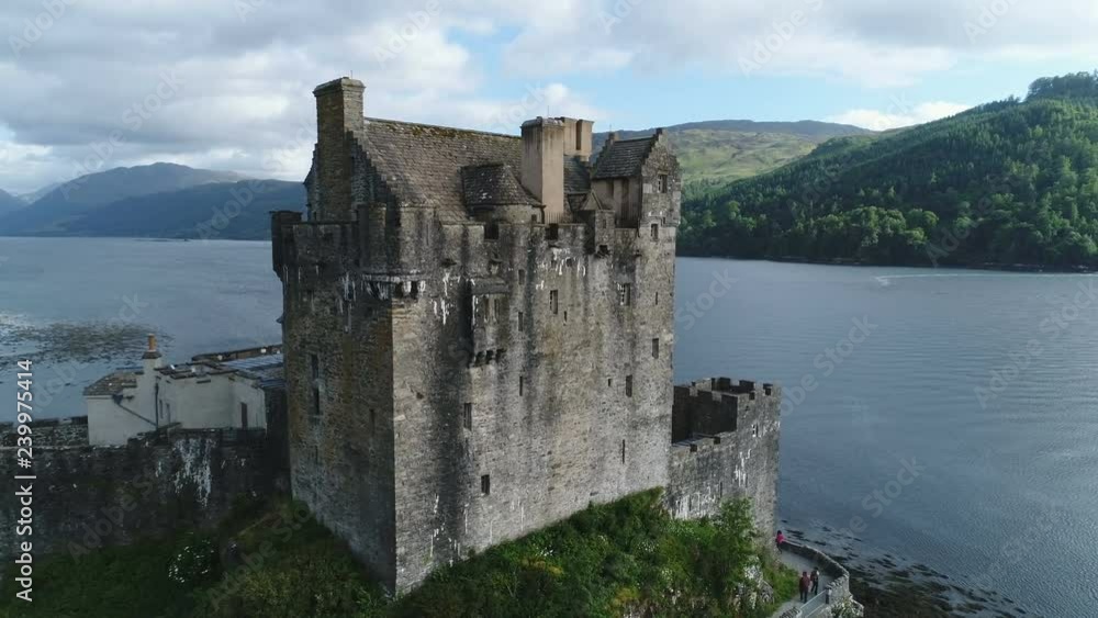 Slow drone shot past renovated Eilean Donan castle, a landmark destination in the highlands of Scotland Slow drone shot past renovated Eilean Donan castle, a landmark destination in the highlands of Scotland