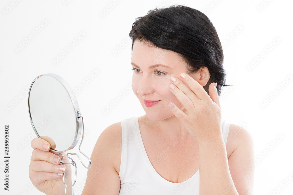Beauty middle age woman with mirror. Face portrait. Spa and anti aging concept Isolated on white background. Plastic surgery and collagen face injections. Wrinkles and menopause. Mock up. Copy space Beauty middle age woman with mirror. Face portrait. Spa and anti aging concept Isolated on white background. Plastic surgery and collagen face injections. Wrinkles and menopause. Mock up. Copy space
