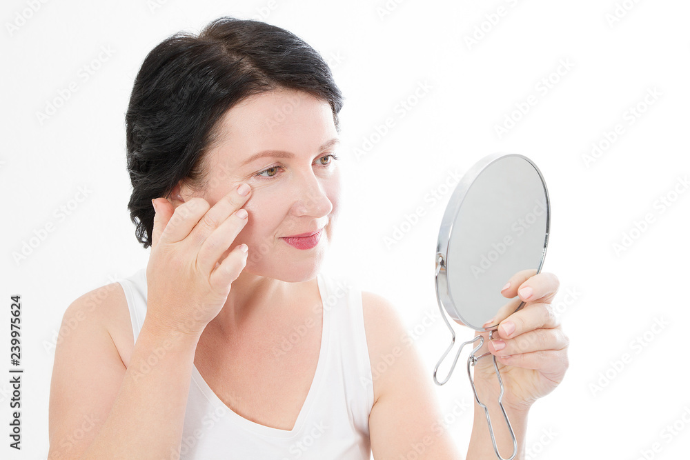 Beauty middle age woman with mirror. Face portrait. Spa and anti aging concept Isolated on white background. Plastic surgery and collagen face injections. Wrinkles and menopause. Mock up. Copy space Beauty middle age woman with mirror. Face portrait. Spa and anti aging concept Isolated on white background. Plastic surgery and collagen face injections. Wrinkles and menopause. Mock up. Copy space