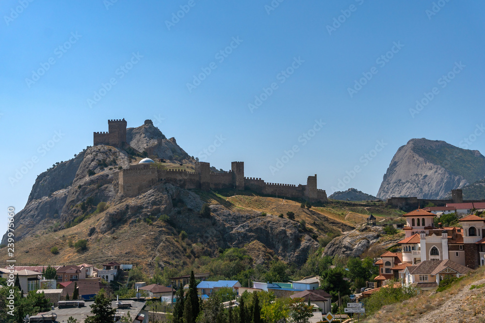 View of the Genoese fortress in the city of Sudak, Crimea, against a blue sky. View of the Genoese fortress in the city of Sudak, Crimea, against a blue sky.