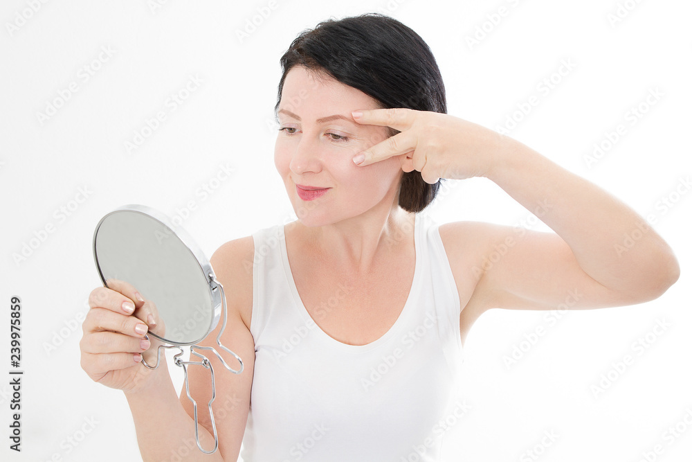 Beauty middle age woman with mirror. Face portrait. Spa and anti aging concept Isolated on white background. Plastic surgery and collagen face injections. Wrinkles and menopause. Mock up. Copy space Beauty middle age woman with mirror. Face portrait. Spa and anti aging concept Isolated on white background. Plastic surgery and collagen face injections. Wrinkles and menopause. Mock up. Copy space