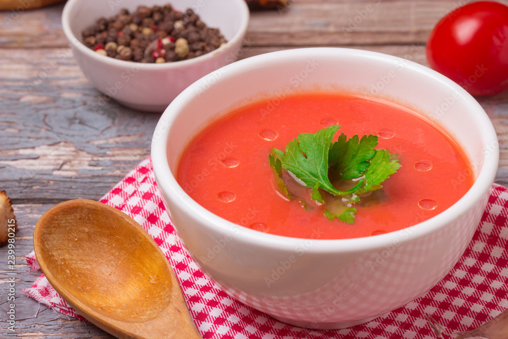 Tomato soup in a white bowl . Traditional red cold gazpacho soup with tomatoes. Spanish cusine Tomato soup in a white bowl . Traditional red cold gazpacho soup with tomatoes. Spanish cusine