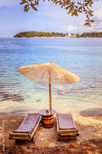 Fototapeta Naklejka Na Ścianę i Meble -  Sunshade and sunlounger on a beach, Lone Bay, Croatia