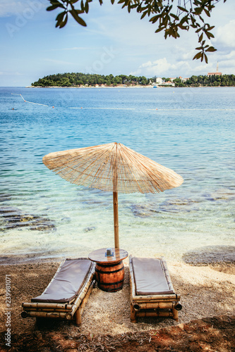 Fototapeta Naklejka Na Ścianę i Meble -  Sunshade and sunlounger on a beach, Lone Bay, Croatia
