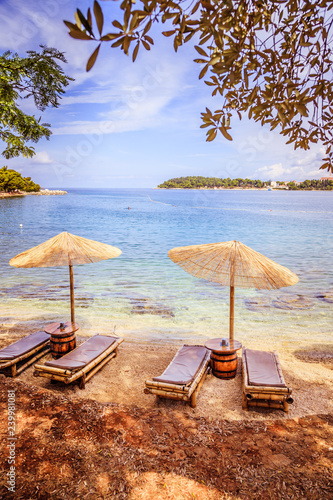 Fototapeta Naklejka Na Ścianę i Meble -  Sunshade and sunlounger on a beach, Lone Bay, Croatia