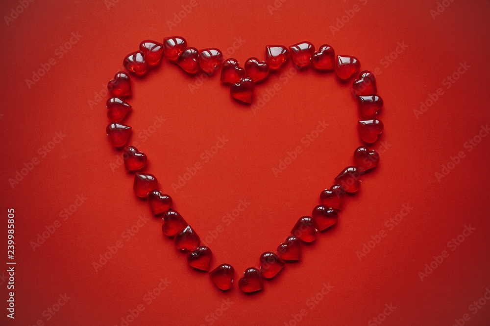 A big heart of many small hearts on a red background. Concept for Valentine's Day or Women's Day. A big heart of many small hearts on a red background. Concept for Valentine's Day or Women's Day.