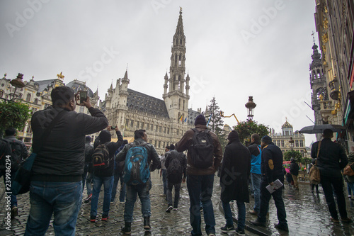 BRUSSELS BELGIUM ON NOVEMBER 24, 2018: People visit The Grand Place or Grote Markt Brussels while with cranes the Christmas tree is mounted