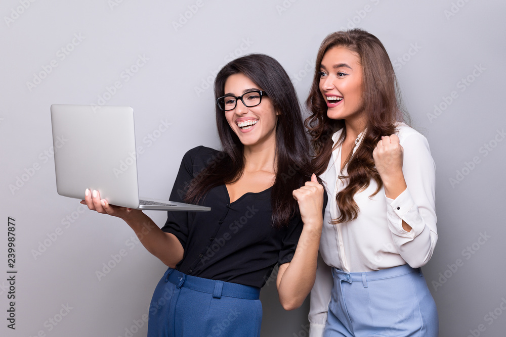 Happy business women working together on laptop Happy business women working together on laptop