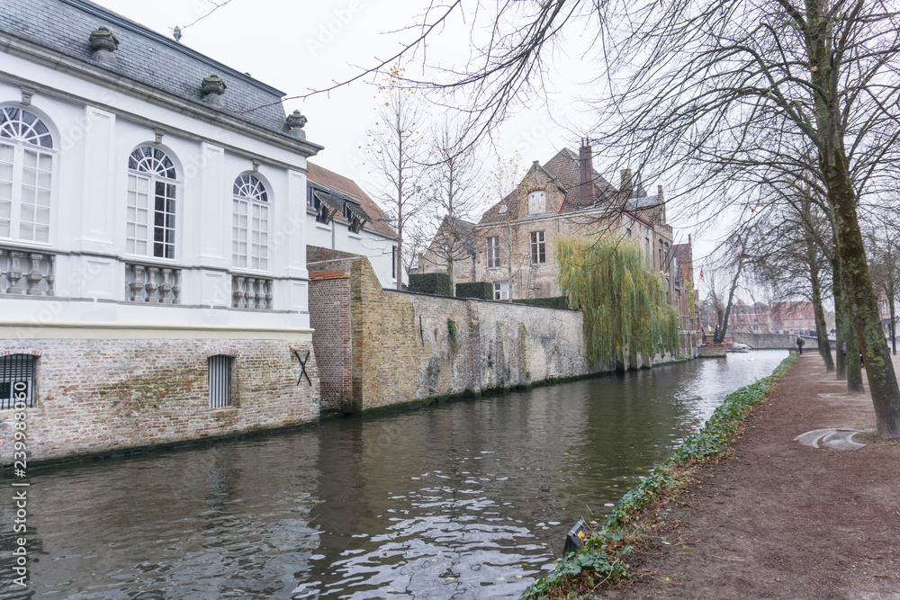 Bruges, Belgium on November 25, 2018: Medieval architecture and channels  in  Bruges the largest city of the province of West Flanders in the Flemish Region of Belgium.