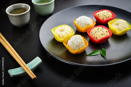 Mochi assortment on plate with chopticks photo