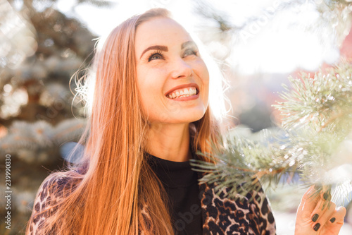 Beautiful stylish woman in the street smiling in sunshine light