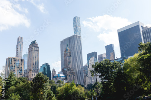 urban scene with trees in city park and skyscrapers in new york, usa © LIGHTFIELD STUDIOS