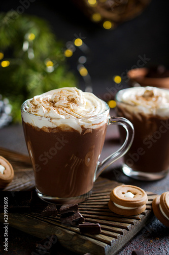 Traditional winter dishes. Traditional drink  Christmas or New Year. Mug of  hot and spicy aromatic chocolate with whipped cream on top.