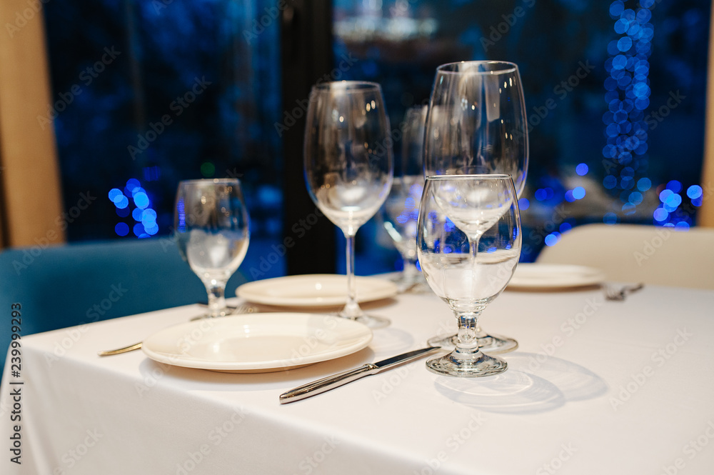 Wine glasses in a restaurant setting. Serving on the table. Crystal glasses for catering Wine glasses in a restaurant setting. Serving on the table. Crystal glasses for catering