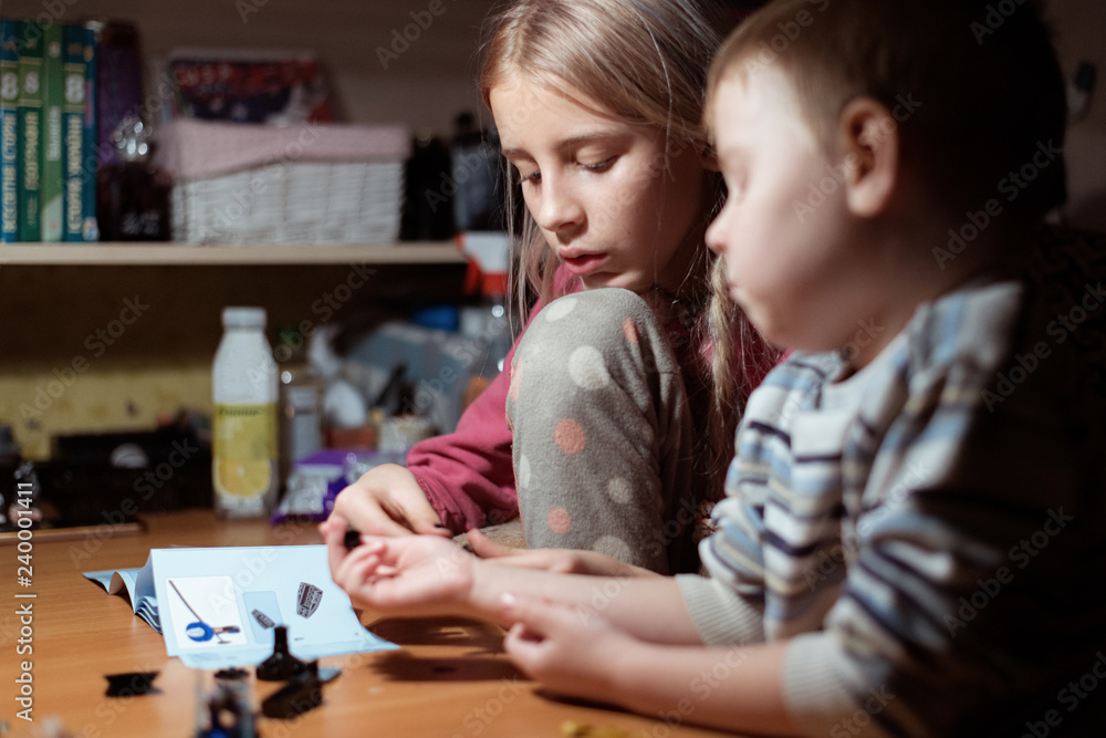 Two children, the elder sister and the younger brother are engaged together. Family relationships between children. Two children, the elder sister and the younger brother are engaged together. Family relationships between children.
