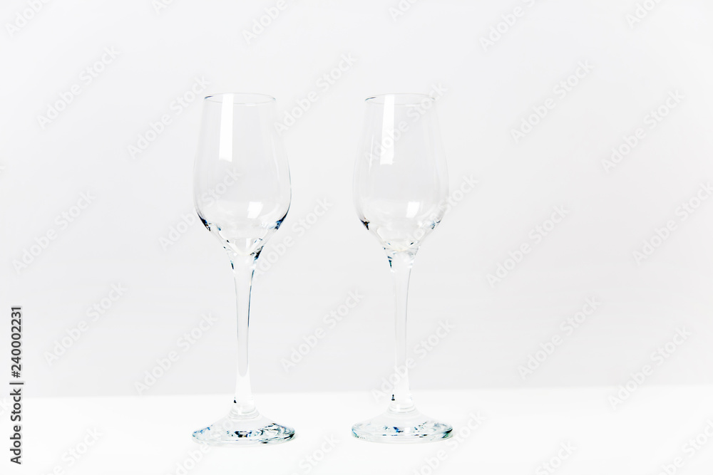 two wine glasses with a garland on a table two wine glasses with a garland on a table